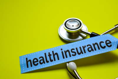 health insurance with stethoscope on yellow background